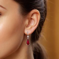 Rubellites are part of the tourmaline family that boasts a vivid fuchsia red color. Filled with a rich bougainvillea purplish red that comes alive thanks to the gems flawless cut, this pair of cascading Rubellite earrings will surely bring a smile to her face. Eye clean and surrounded by sparkling diamonds, there won’t be any outfit these rubellites cannot flatter. Red Diamond Earrings For Anniversary, Luxury Red Brilliant Cut Earrings, Red Ruby Pear-shaped Earrings, Red Diamond Earrings With Prong Setting, Classic Red Diamond Earrings With Brilliant Cut, Red Diamond Drop Earrings For Formal Events, Red Diamond Drop Earrings For Formal Occasions, Red Brilliant Cut Diamond Earrings For Wedding, Red Brilliant Cut Fine Jewelry Earrings