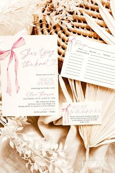 the wedding stationery is laid out next to some fan shaped paper and other items