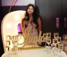 a woman standing next to a table with champagne glasses