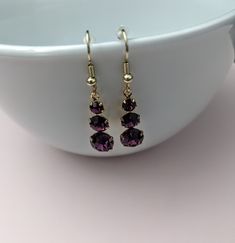 This listing is for one pair Amethyst and gold toned earrings.  Three stones.  Ear wires  come with rubber stopper to keep earrings secure.  Very pretty. #176 Purple Hook Earrings For Anniversary, Purple Earrings With Ear Wire For Anniversary, Gold Amethyst Drop Earrings, Purple Anniversary Earrings With Ear Wire, Nickel Free Purple Crystal Drop Earrings, Purple Drop Crystal Earrings Nickel Free, Purple Crystal Earrings With Ear Wire As Gift, Purple Crystal Earrings For Gift, Purple Crystal Earrings Matching Set For Gift