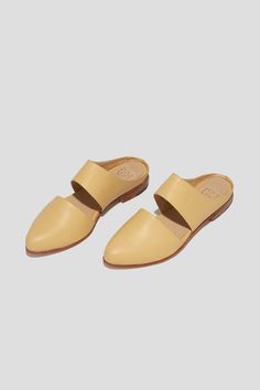 The mule is ZX’s perennial flat, inspired by traditional babouche slippers. With its sleek cut-out upper and almond shaped toe, this style makes feeling comfortable and pulled-together an easy task for days filled with lots of activity. This pair is crafted from pale yellow kidskin. Style yours with statement pants for a chic vacation look. Who it’s for: The woman with refined style who likes to go places by foot. Kidskin leather upper and undyed vegetable-tanned leather lining. Leather sole and stacked heel. Handmade in Argentina. Babouche Slippers, Statement Pants, Vacation Looks, Almond Shaped, Refined Style, Loafer Mules, Flat Boots, Heeled Loafers, Pale Yellow