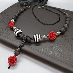 Embrace your Darker Side with this gothic style Morticia Adjustable Necklace. This is made with natural lava stone beads and has two lengths that can be worn. Wear casual or dressy, whatever your heart desires. Look like a true Goddess of Darkness and pair with our matching Bracelets Set and Earrings. Embrace the Darker Side! Details: Fashion Jewelry ~ Handmade Full Length Necklace: 22.5 inches Clavicle/ Choker Size: 16.5 inches Pendant Length: 42mm Gothic Bracelet, Dark Jewelry, Natural Stones Necklace, Punk Jewelry, Stone Beaded Necklace, Goth Jewelry, Witchy Jewelry, Handmade Fashion Jewelry, Girl Jewelry