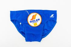 Vintage swimwear - Solar Made in W-Germany 1980s Athletic swim brief in mid blue color. Sporty fit. High waisted. Shiny texture. White Solar logo on left front . Elastic waist with lace. Lined on front . Label inside. In very good condition. Deadstock item with its authentic cardbord label and/or stickers. 86% Polyamide 14% Elasthan Size:  5-M          Measurements (flat):  Waist: 31cm to 43cm - 12,2" to 16,9"  Leg opening: 20cm - 7,8" Crotch front: 27cm - 10,6" Crotch back: 23cm - 9" Side: 6cm Blue Briefs For Water Polo, Retro Blue Bottoms For Poolside, Retro Blue Swim Bottoms, Retro Blue Swimwear For Swimming, Retro Blue Swimming Bottoms, Solar Logo, 1980s Men, Athletic Swim, Vintage Swim