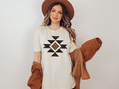 Really cute Aztec pattern tee, perfect for your next concert or rodeo. This is a unisex size T Shirt, please refer to the size chart pictured in the listing for choosing your perfect size. You will fall in love with this super soft tee with just the right amount of stretch! Its wildly comfortable and the unisex cut is flattering. It would make the perfect gift or grab it for yourself! It is sure you be your new favorite t shirt~ Our shirts are made with Direct to garment printing, not vinyl! Whi Trendy Relaxed Fit T-shirt For Rodeo, Cheap Fitted Western Style T-shirt, Trendy Cotton T-shirt For Rodeo, Western Style Relaxed Fit T-shirt With Screen Print, Cheap Western Style T-shirt For Rodeo, Cowgirl Gifts, Western Outfit, Clothes Aesthetic, Aesthetic T Shirts