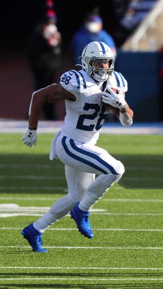 a football player is running with the ball