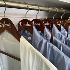 clothes hanging on wooden hangers with names