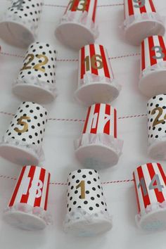 red and white candy wrappers with gold numbers on them are lined up in rows