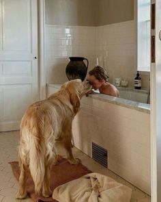 a man and his dog are in the bathroom