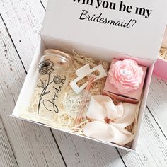 a box that has some items in it on a table with the words, why you be my bridesmaid?