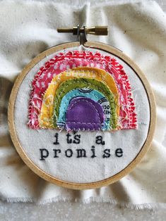 an embroidered rainbow with the words it's a promise