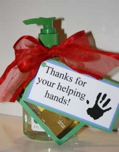 a hand sanitizer in a glass bottle with a red ribbon around it and a sign that says thanks for your helping hands