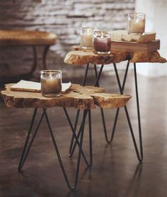 three wooden tables with candles and books on them