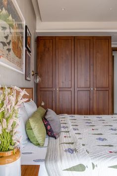 a large bed sitting in a bedroom next to wooden closets