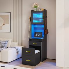 a living room with a white couch and black cabinet