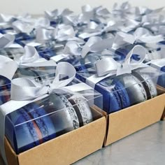 two boxes filled with cookies wrapped in white ribbon