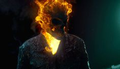 a man with fire on his face in the dark