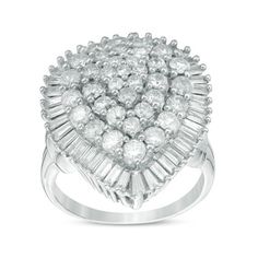 a white gold ring with diamonds on the sides and an oval shaped center surrounded by baguets