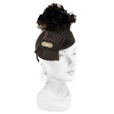 1930s Brown Sculpted beaver fur felt hat with an asymmetrical silhouette. Decorated with feather flowers, and a pleated grow-grain ribbon centered with an elongated brass art deco accent. Ranch Hat, 1930s Brooch, Art Deco Accents, Hat With Feather, Feather Flowers, Large Brim Hat, Types Of Hats, Brass Art, Feather Hat