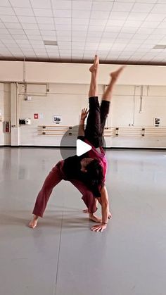 two people in a dance studio doing a handstand