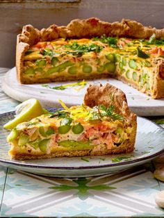 a slice of quiche on a plate next to the rest of the pie, ready to be eaten