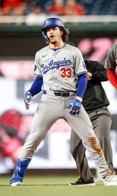 two baseball players standing next to each other on a field