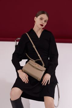 Carry your essentials in the seamless contours of the Unlocked Top Handle Bag, whether by the adjustable shoulder strap or top handle. The design takes classic elegance and twists it with playful modern hues and color blocks. Whether day or night, you'll find yourself instinctively reaching for this chic and easy-to-wear masterpiece. High-end Flap Bag With Detachable Strap, Designer Handheld Business Shoulder Bag, High-end Shoulder Bag With Top Carry Handle, High-end Satchel For Daily Use, High-end Satchel Shoulder Bag, Luxury Satchel Flap Bag For Daily Use, High-end Top Handle Satchel For Daily Use, High-end Business Bags, High-end Satchel With Detachable Strap