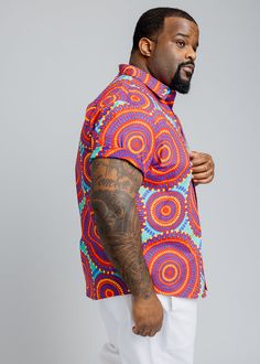 Style#M2015TRC Step out with confidence in our Keyon Men's African Print Button-Up Short Sleeve Shirt in Turquoise Red Circles. This dynamic shirt is a statement piece for the contemporary man who embraces bold style. Shop the matching items. *Disclaimer* Please refer to the fabric image for the true color of this product. Features: Collared Neckline Pocket at Chest 100% Cotton Designed in the USA, imported *Print placement may vary* Care Instruction: Hand Wash Cold. Mild Detergent. Do Not Bleac Casual Red Shirt With Vibrant Print, Vacation Button-up Shirt With Vibrant Print, Vibrant Multicolor Short Sleeve Shirt, Vibrant Red Short Sleeve Top, Workout Accessories, Bold Fashion, Head Wraps, African Print, Men Short Sleeve