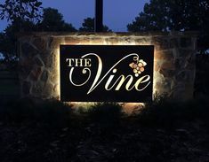 the sign for the winery is lit up at night