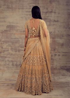 Minimalist Yet Elegant Gold Lehenga For Our Beautiful Ladies! All the women - whether they are from India or any other country have always embraced the unparalleled charm of Lehengas. Lehenga has become the preferable attire for a wedding or special occasion owing to the kind of comfort and elegance this attire provides. Keeping in mind your taste and class, Ruhani Collection have come up with this beautiful gold-coloured lehenga. Beautified with silver and gold embroidery, this lehenga is enoug Traditional Marriage Sets With Intricate Embroidery, Elegant Fitted Wedding Dress With Traditional Drape, Traditional Gown With Zari Work For Marriage, Elegant Floor-length Anarkali Set For Ceremony, Full Length Lehenga With Resham Embroidery For Reception, Wedding Saree In Gold With Intricate Embroidery, Traditional Marriage Wear With Intricate Embroidery, Gold Wedding Dress With Zari Work In Traditional Drape, Bollywood Style Gold Wedding Dress With Traditional Drape