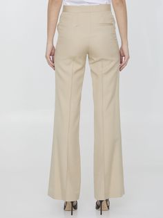 Iconic flare pants in sand-colored viscose. It features zip, button and hook-and-eye closure, two side welt pockets and one rear welt pocket. Regular fit. The model is 178cm tall and wears size IT 40. Size nationality: IT Product number: 6017751 Product code: 6400933DU7012600 Composition: 100% viscose Platform Wedge Heels, Loafer Sneakers, Premium Brands, Dress Pant, Pump Sandals, Dress With Cardigan, Cardigan Jacket, Clothes Collection, Flare Pants