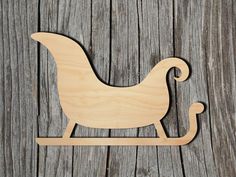 a wooden sleigh with a horse on it sitting on top of a wooden surface