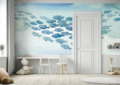 a child's room with blue clouds painted on the wall