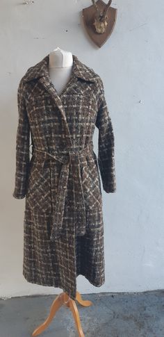 "Vintage 50s 60s heavy tweed wool mix brown taupe and cream tweed wool coat fully lined  with raglan sleeve and matching belt.  Beautifully tailored coat with two large patch pockets. Size large Measurements are approximate and are taken laid flat (bust/chest/waist/hips are then doubled) make sure to leave yourself some \"wiggle room\". Label: unbranded Condition:  Excellent Fabric:  60% wool  25% nylon 10 acrylic - tweed Mannequin size UK 14 Fits like large - UK 14 bust 42\" waist 42\"\" Hips 48\" Shoulder to hem 44\" DELIVERY INCLUDING INTERNATIONAL DELIVERY - I COMBINE POSTAGE SO WHEN YOU PURCHASE MORE THAN ONE ITEM YOU WILL ONLY HAVE TO PAY FOR THE DELIVERY COST OF ONE ITEM.  So you can save money on your postage by ordering more than one item at the same time. Please Visit my new ETSY Brown Tweed Long Coat, Brown Tweed Wool Long Coat, Brown Tweed Long Wool Coat, Fitted Brown Wool Coat For Fall, Retro Wool Tweed Jacket For Winter, Retro Winter Wool Tweed Jacket, Brown Tweed Wool Coat For Fall, Retro Winter Tweed Jacket, Vintage Wool Tweed Jacket For Fall