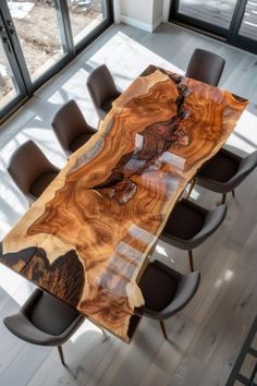 a dining table made out of wood with chairs around it and windows in the background