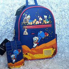 New Loungefly Disney's Duck Tales Donald Duck's Uncle Scrooge Mcduck Backpack Along With Nephews Huey, Dewey And Louie. Scrooge Backpack Measurements Appropriately 9" X 11" X 4". See Pictures For More Details And Measurements. Price Is Firm. Please Do Not Send Offers Unless Bundled With Other Items With A Reasonable Offer. Combine Orders Into A Bundle And Pay For Only One Shipping. C-44 C-32 C51 Blue Disney Backpack For Daily Use, Blue Disney Backpack With Adjustable Strap, Blue Disney Backpack For Travel, Blue Disney Travel Backpack, Disney Rectangular Backpack For Everyday Use, Disney Themed Rectangular Backpack For Everyday Use, Blue Backpack With Case For Everyday Use, Themed Travel Bag With Case Included, Huey Dewey And Louie