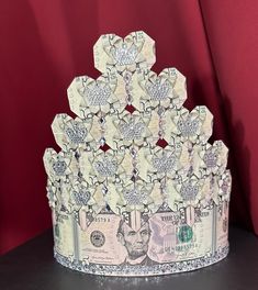 a crown made out of dollar bills sitting on top of a table