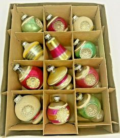 an open box filled with assorted christmas ornaments