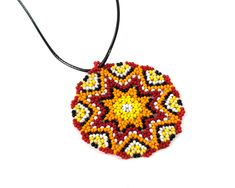 Huichol necklace is handmade from seed beads in Native american style. The size of huichol necklace is 2.4 inches (6 cm). Huichol necklace comes with a cord. Cord has adjustable chain its length - 17.3" - 19.3" (44 cm - max 49 cm). 100% handmade. Made of High Quality Czech beads PACKAGING: Arrives in a white jewelry gift box - ready to be given as a gift. OTHER VARIATIONS Blue mandala pendant - https://www.etsy.com/listing/641699546/mandala-necklace-hippie-pendant-seed?ref=shop_home_active_20 Gr Traditional Multicolor Medallion Beaded Necklaces, Traditional Medallion Beaded Necklaces In Multicolor, Traditional Multicolor Medallion Beaded Necklace, Red Amulet Beaded Necklaces With Colorful Beads, Multicolor Bohemian Medallion Beaded Necklaces, Multicolor Bohemian Medallion Beaded Necklace, Artisan Multicolor Medallion Beaded Necklaces, Red Artisan Beaded Necklaces For Crafting, Artisan Red Beaded Necklaces For Crafting