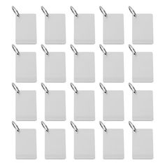 many white tags with metal clips attached to each other on a white background stock photo