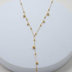 our Walking On A Dream Lariat makes an elegant statement for any occasion. with its playful design, it adds a stylish edge to your outfit, effortlessly capturing the eye of any crowd. 18k gold pvd over 316L stainless steel can be worn from 16-18" 4" lariat drop 3-5mm beads 1mm chain Adjustable Long Drop Gold Necklace, Gold Dangle Lariat Necklace For Parties, Adjustable Yellow Gold Long Drop Lariat Necklace, Adjustable Yellow Gold Plated Lariat Necklace, Adjustable Yellow Gold Plated Drop Necklace, Dainty Adjustable Gold-tone Lariat Necklace, Gold Lariat Necklace With Adjustable Dangle, Modern Gold Drop Necklace With Adjustable Chain, Trendy Gold Long Drop Earrings