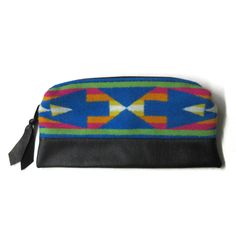 This large pouch measures about 9.5" x 5.25". Pendleton calls this wool pattern "San Gabrielle Sapphire". I used a quality black leather for the entire back and wrapped over the bottom front for durability.  I used a quality zipper across the top with a zipper pull I made from leather and cut it into my signature arrows for more interest. This is not lined. The blanket weight wool I use is reversible and with all seams completely finished, the inside is as beautiful as the outside. Great for cos Leather Zipper Pouch, Make Up Pouch, Pendleton Woolen Mills, San Gabriel, Large Pouch, Pendleton Wool, Zippered Pouch, Pencil Pouch, Purse Pouch