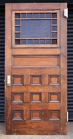 an old wooden door on the side of a building