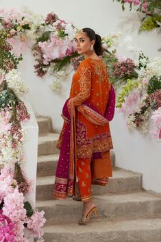 Pakistani Wedding Dress in Salwar Kameez Dupatta Style is a traditional attire that will give you a breathtaking look that is a perfect blend of trend and royalty. Sequins, dabka, naqshi, and zardosi make this Salwar Kameez an epitome of beauty and your priority to have a stunning look. Pakistani Kameez: The Kameez in an alluring orange shade and it comes in net fabric. The beautiful hand-crafted details of goldwork and embroidery enhance the glamour of this kameez. Crystals, zardosi, dabka, naqshi, and sequins give a glamorous touch to the beautiful kameez. Salwar Kameez: The heavily embellished kameez is paired with salwar, creating a lavish Pakistani Wedding Dress. The salwar is in orange color and is adorned with block print and embellished borders. Embroidery and gold work make this P Unstitched Jamawar Sharara For Wedding, Wedding Jamawar Salwar Kameez With Traditional Drape, Traditional Naqshi Semi-stitched Lehenga, Designer Wear Dupatta In Dola Silk With Naqshi, Wedding Kurta With Dabka Work On Jamawar, Designer Semi-stitched Sharara In Jamawar, Designer Semi-stitched Jamawar Sharara, Bollywood Style Semi-stitched Jamawar Sharara, Dabka Embroidered Banarasi Silk Saree