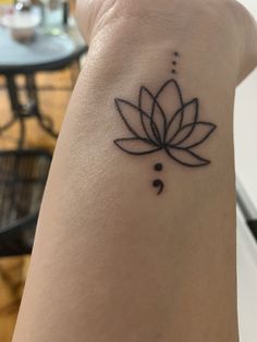 a tattoo on the arm of a woman with a lotus flower in it's center