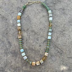 This mixed media natural stone beaded necklace is perfect worn layered or by itself. Crafted in true mixed-media style, it blends tones of sea, sand, and sunshine with geometric shapes of cubes, spheres, and cylinders. Square Beaded Necklace, Bohemian Amazonite Single Strand Beaded Necklace, Minimalist Natural Stone Beaded Necklaces For Healing, Minimalist Beaded Necklaces With Natural Stones For Healing, Rectangular Natural Stones Necklace For Healing, Everyday Bohemian Crystal Necklaces With Gemstone Beads, Bohemian Necklace With Rectangular Gemstone Beads, Artisan Beaded Necklaces With Natural Stones For Everyday, Artisan Beaded Necklace With Natural Stones