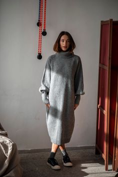 Keep yourself cozy and warm during those cold autumn and winter months in this versatile, soft Merino wool sweater dress designed to last you years. The oversized fit comes with a calf-length hem, which is ribbed like the sleeve ends and the turtleneck. The roll neck is so chunky that it can easily replace the scarf in a windy day. The long ribbed cuffs make the dress stand out and give grace to your hands, whereas the raglan sleeves give enough room for the shoulders. This is a timeless wool dr Wool Long Dress, Wool Dress Winter, Grey Dress Outfit, Dress With Sweater, Knitted Dress Outfit, Wool Dresses, Cozy Knitwear, Outfit Knit, Grey Clothing