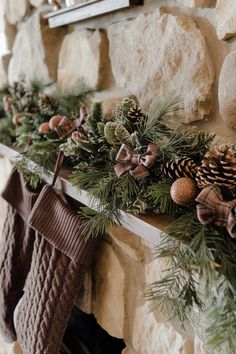 stockings and pine cones are hanging on the mantle