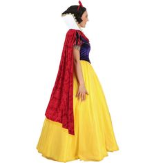 a woman in a yellow and red dress with a cape on her head, standing