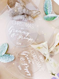 christmas ornament with glittered leaves and bows on top of a clear acrylic plate