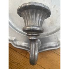 an old fashioned metal object on a wooden floor